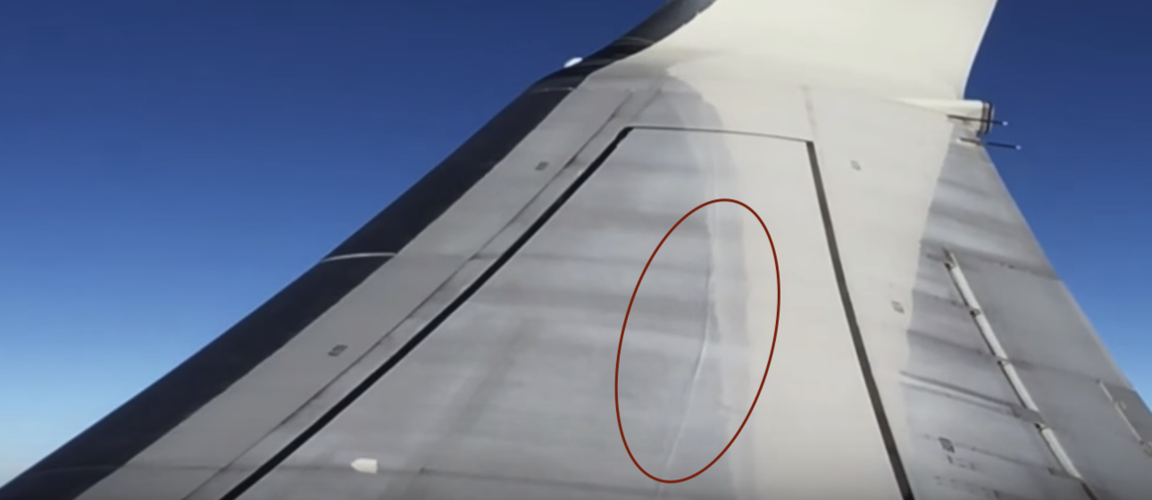 A small shock wave dancing on the wing of a Boeing 737 at cruise speed — seen from a passenger window